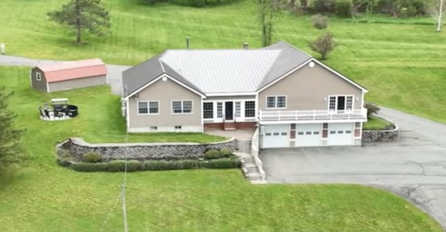 208 N Caribou Rd, Presque Isle, ME 04769 - exterior space with a garage, a lawn, a deck, and aphalt driveway