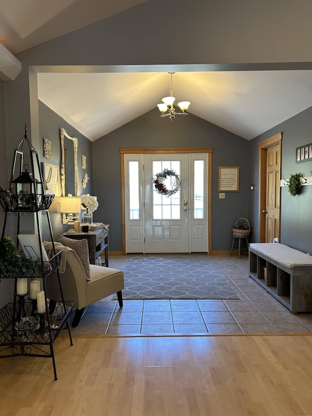 208 N Caribou Rd, Presque Isle, ME 04769 - entrance foyer featuring baseboards, a notable chandelier, vaulted ceiling, and wood finished floors