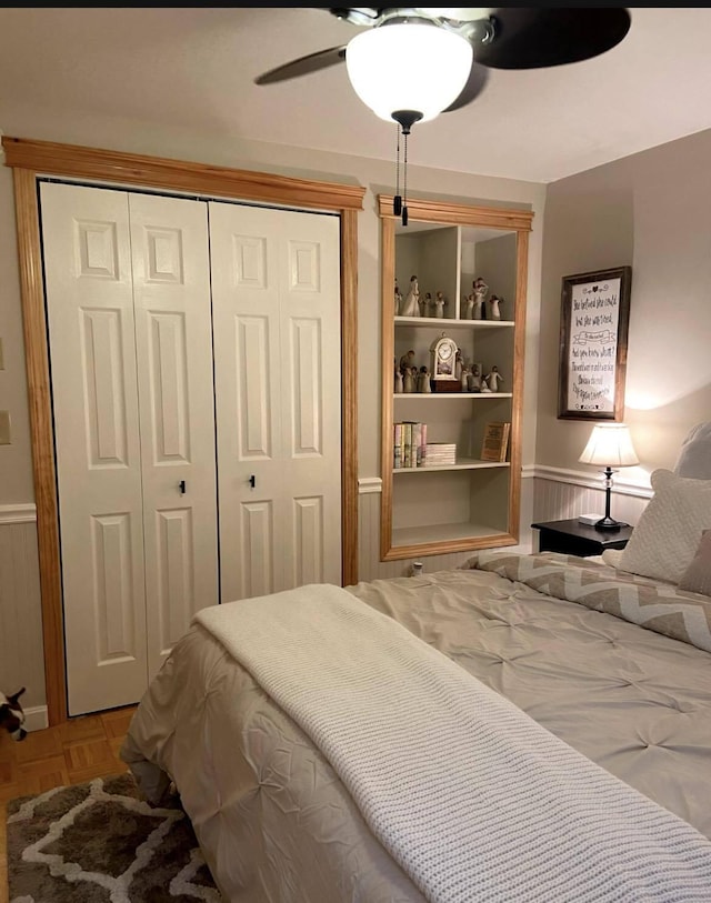 208 N Caribou Rd, Presque Isle, ME 04769 - bedroom with a ceiling fan, a wainscoted wall, and a closet