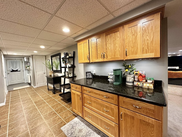 208 N Caribou Rd, Presque Isle, ME 04769 - kitchen featuring recessed lighting, dark stone counters, and brown cabinetry