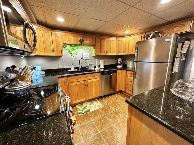 208 N Caribou Rd, Presque Isle, ME 04769 - kitchen featuring light tile patterned flooring, recessed lighting, a sink, dark stone countertops, and appliances with stainless steel finishes