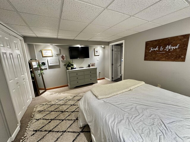 208 N Caribou Rd, Presque Isle, ME 04769 - bedroom with baseboards, light colored carpet, and a paneled ceiling
