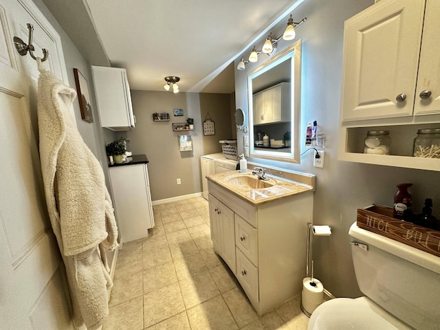 208 N Caribou Rd, Presque Isle, ME 04769 - bathroom with vanity, baseboards, tile patterned floors, and toilet