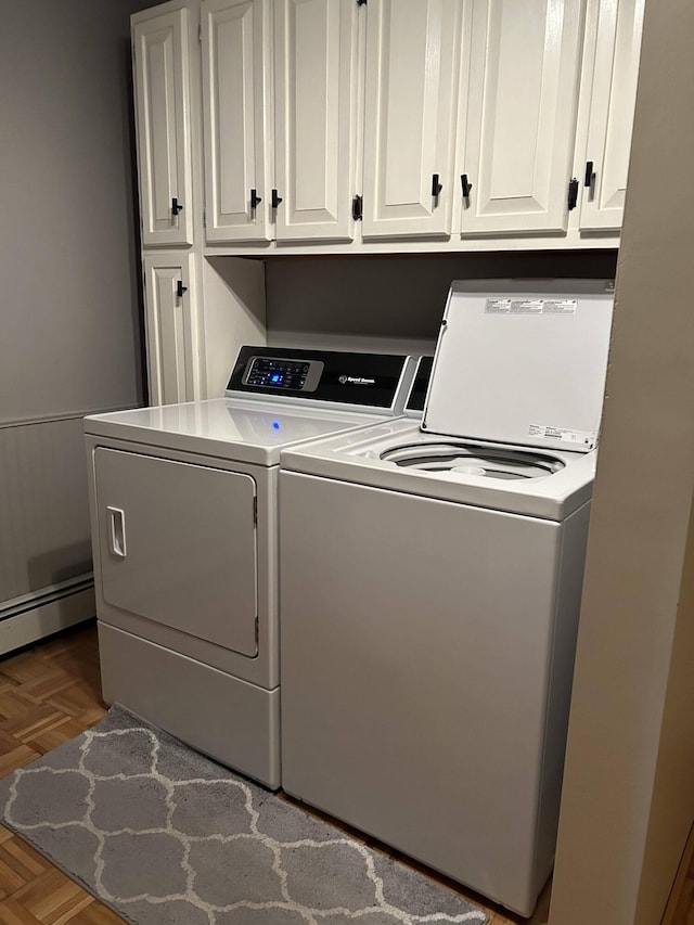 208 N Caribou Rd, Presque Isle, ME 04769 - laundry room with washing machine and clothes dryer, a baseboard heating unit, and cabinet space