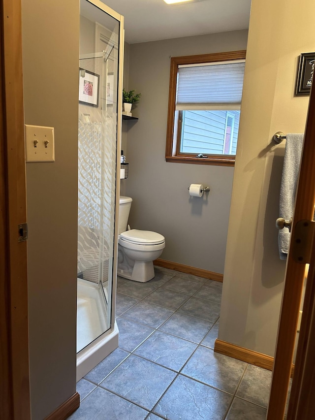 208 N Caribou Rd, Presque Isle, ME 04769 - full bath featuring toilet, baseboards, a shower stall, and tile patterned flooring
