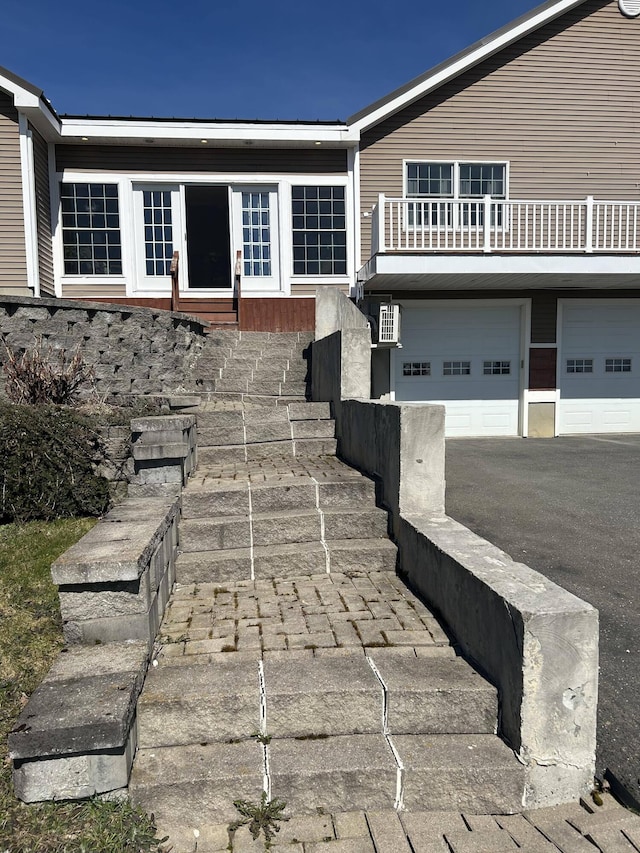 208 N Caribou Rd, Presque Isle, ME 04769 - view of front facade featuring an attached garage, aphalt driveway, and a balcony