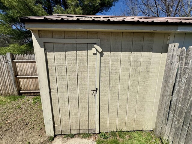 view of shed featuring fence