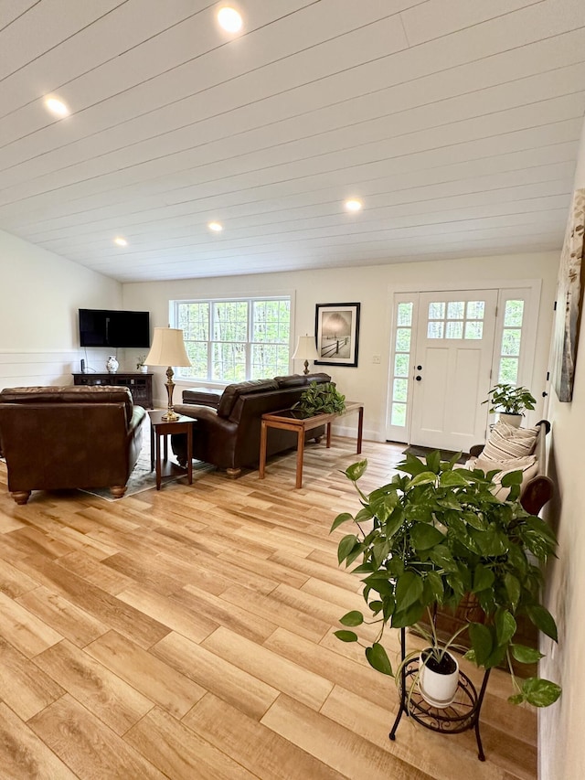 living area with light wood-type flooring, healthy amount of natural light, and recessed lighting