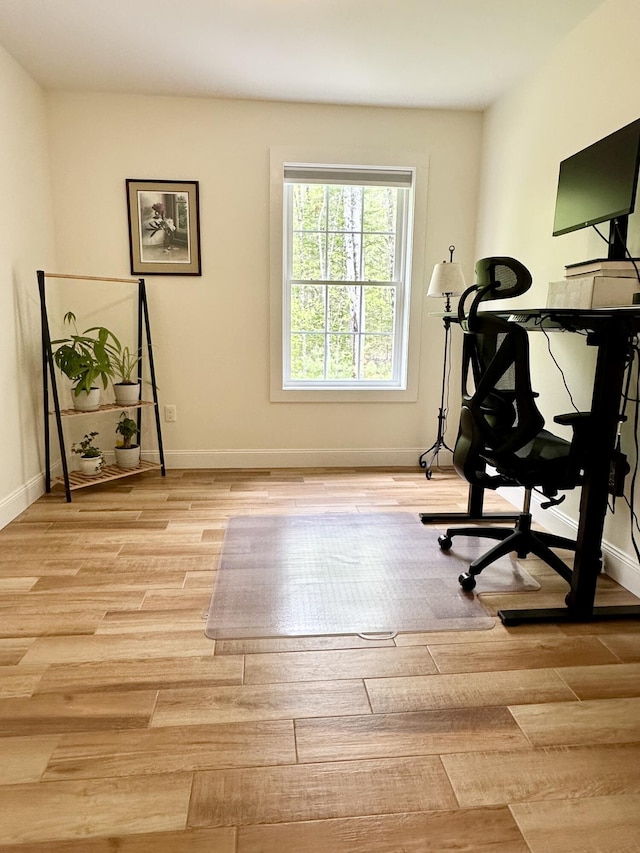 office area with light wood-style flooring and baseboards