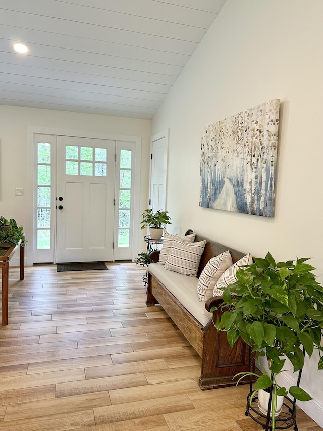 foyer with light wood finished floors, recessed lighting, and lofted ceiling