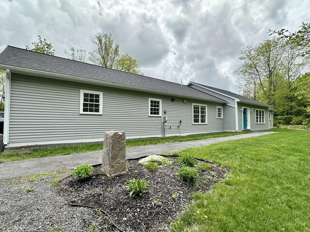 rear view of property featuring a yard