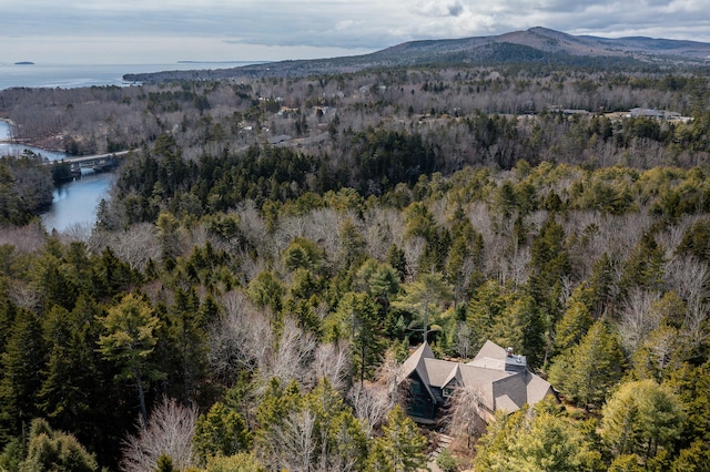 aerial view featuring a water and mountain view and a forest view