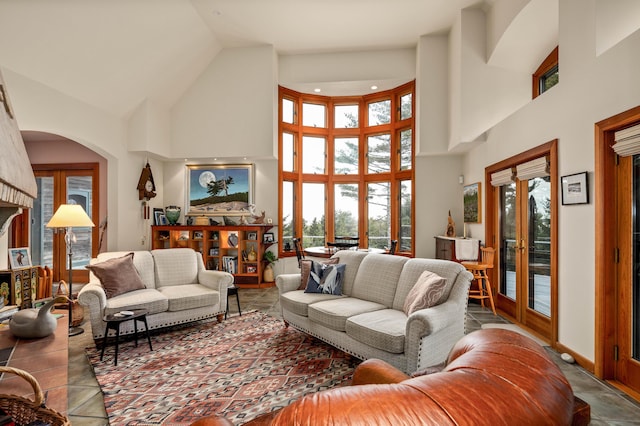 living room with arched walkways, high vaulted ceiling, and a healthy amount of sunlight