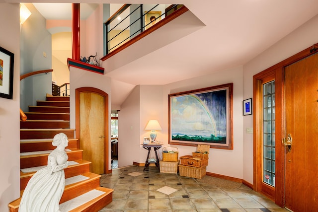stairway with baseboards and tile patterned flooring