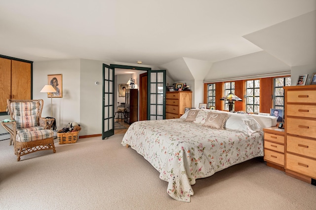 bedroom featuring light colored carpet and baseboards