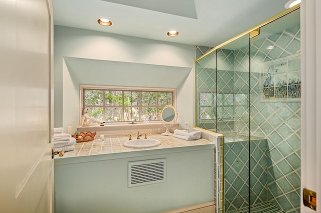 bathroom with recessed lighting, a stall shower, and vanity