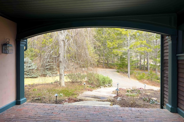 exterior space featuring a wooded view
