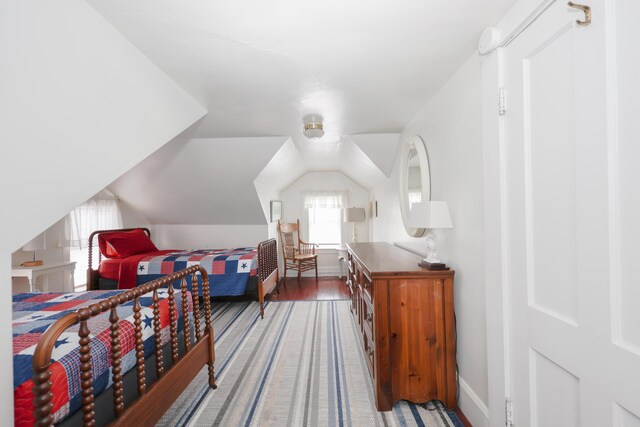 bedroom featuring baseboards and vaulted ceiling