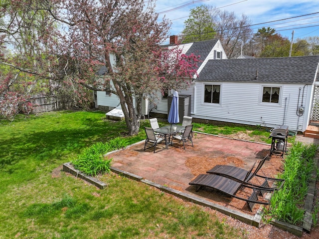 view of green lawn with a patio area