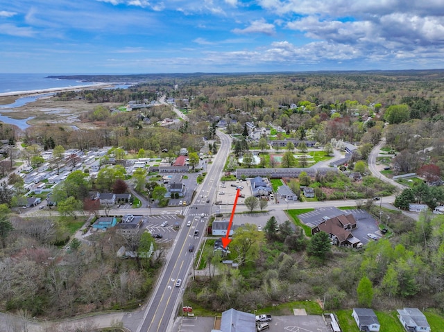 aerial view of property's location featuring a large body of water and nearby suburban area