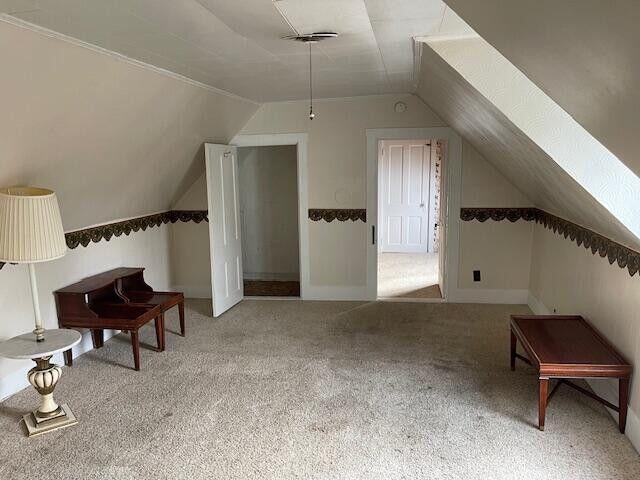bonus room with carpet floors, baseboards, and lofted ceiling