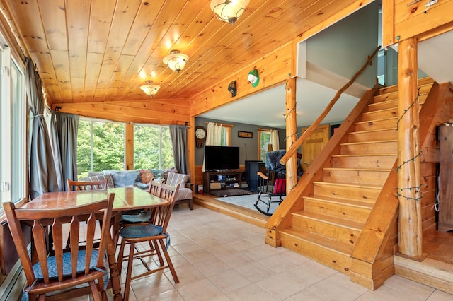 dining room featuring stairs, wooden walls, wood ceiling, light tile patterned floors, and vaulted ceiling