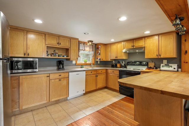 kitchen with open shelves, wood counters, stainless steel appliances, a peninsula, and under cabinet range hood