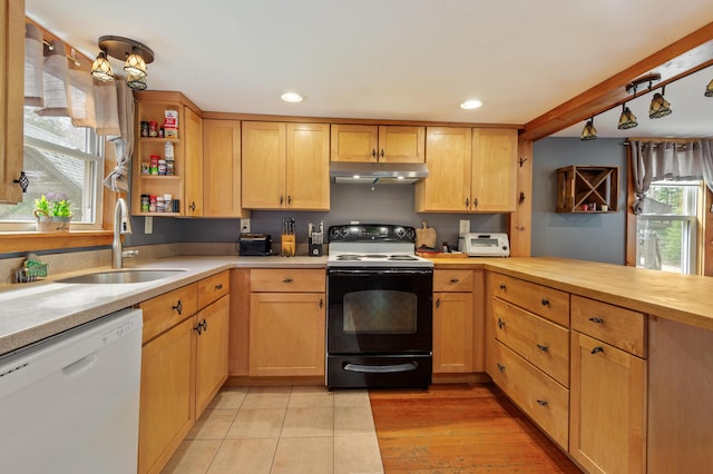 kitchen featuring open shelves, black range with electric cooktop, white dishwasher, under cabinet range hood, and a sink