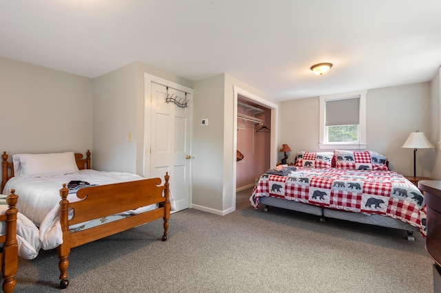 carpeted bedroom featuring baseboards and a closet