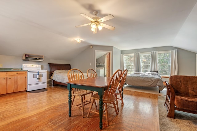 dining space featuring light wood-style flooring, ceiling fan, and lofted ceiling