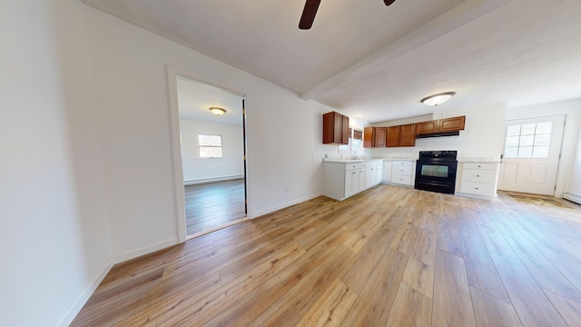 kitchen featuring light countertops, ceiling fan, black electric range oven, and light wood finished floors