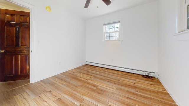 unfurnished room with a ceiling fan, light wood-style flooring, and baseboard heating