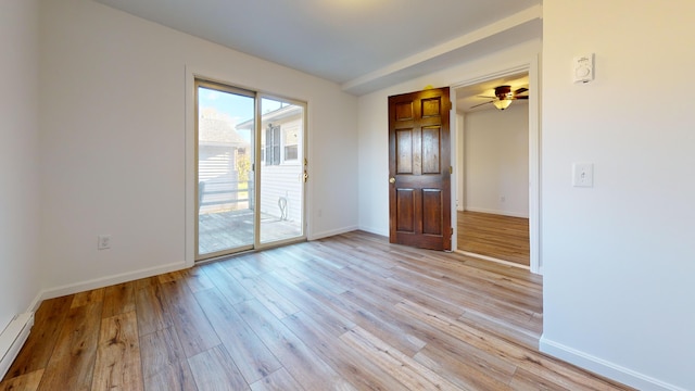 empty room with baseboards, light wood finished floors, ceiling fan, and baseboard heating