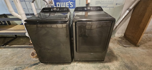 washroom with washing machine and clothes dryer and laundry area