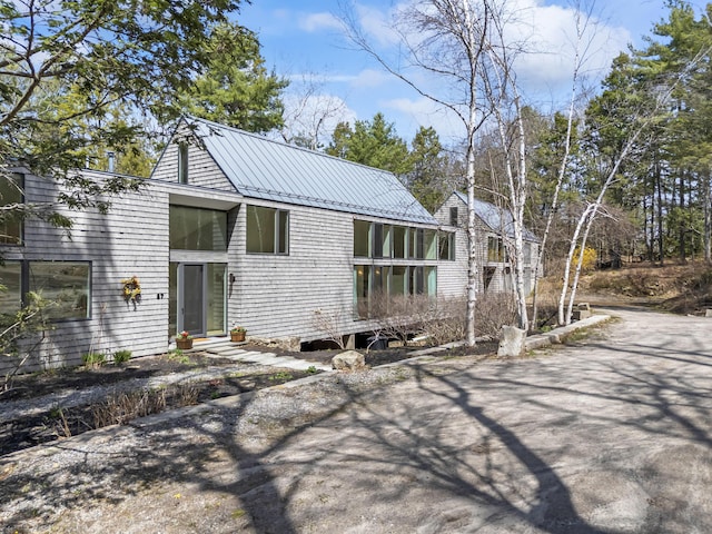 27 Carter Dr, West Bath, ME 04530 - view of front facade with driveway and metal roof