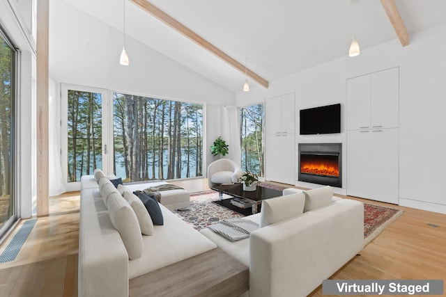 27 Carter Dr, West Bath, ME 04530 - living room featuring a lit fireplace, beamed ceiling, high vaulted ceiling, and wood finished floors