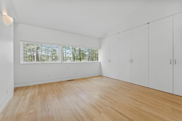 27 Carter Dr, West Bath, ME 04530 - unfurnished bedroom featuring light wood-style floors, vaulted ceiling, baseboards, and visible vents