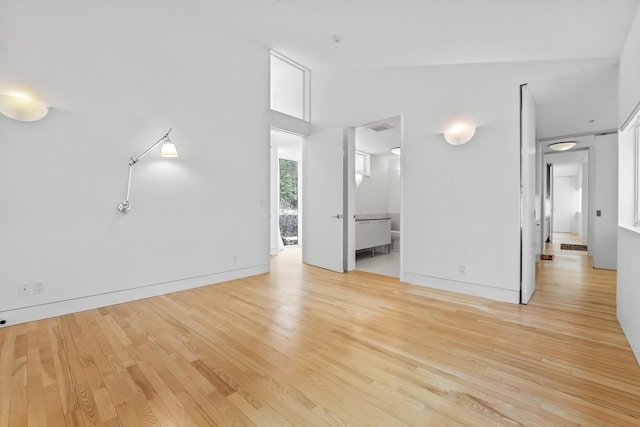 27 Carter Dr, West Bath, ME 04530 - unfurnished living room with baseboards, visible vents, light wood-style flooring, and lofted ceiling