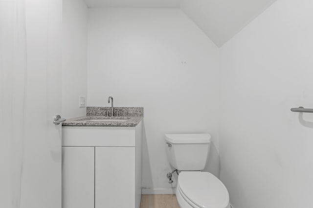 27 Carter Dr, West Bath, ME 04530 - bathroom featuring vaulted ceiling, vanity, toilet, and wood finished floors