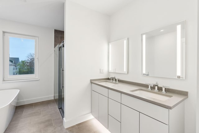 130 Morning St Unit 3A, Portland, ME 04101 - bathroom with double vanity, a freestanding bath, and a stall shower