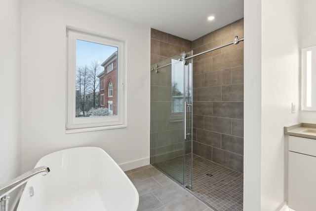 130 Morning St Unit 3A, Portland, ME 04101 - full bathroom featuring a freestanding tub, a stall shower, tile patterned flooring, vanity, and recessed lighting