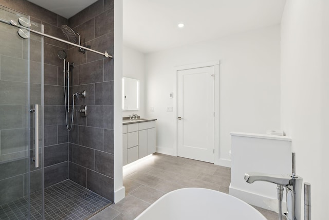 130 Morning St Unit 3A, Portland, ME 04101 - bathroom featuring a shower stall, vanity, a freestanding tub, recessed lighting, and tile patterned floors