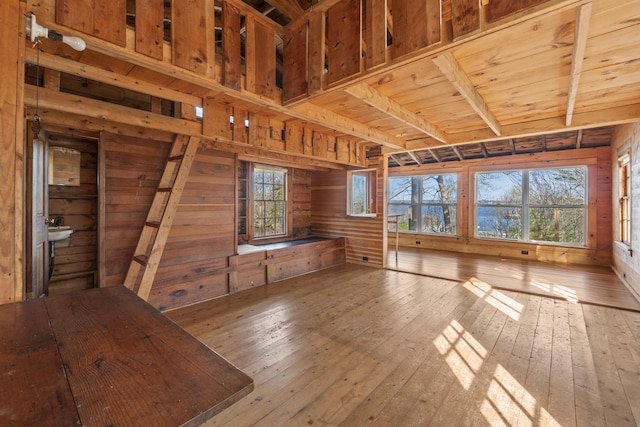 15 Blueberry Hill Rd, Georgetown, ME 04548 - unfurnished living room featuring wood walls, wood-type flooring, and a healthy amount of sunlight
