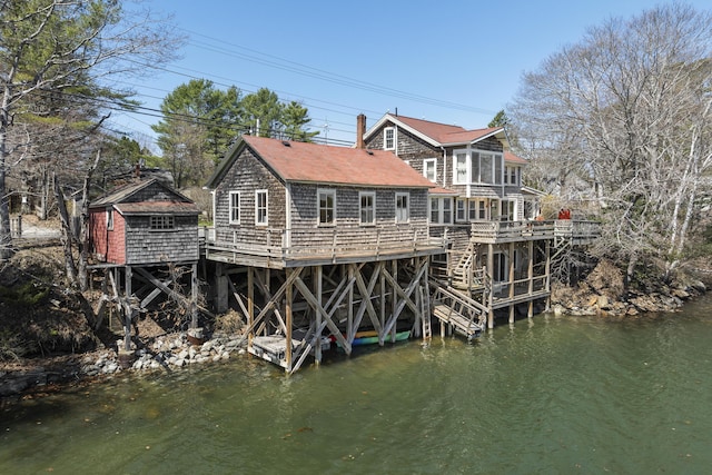 37 Harpswell Islands Rd, Harpswell, ME 04079 - rear view of property with roof with shingles, a chimney, and a deck with water view