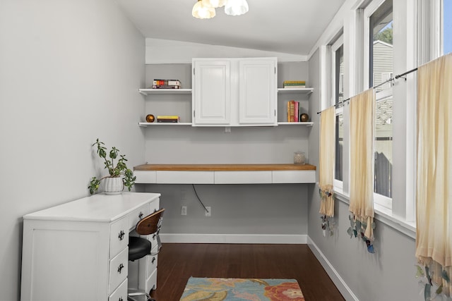 37 Harpswell Islands Rd, Harpswell, ME 04079 - home office featuring baseboards, vaulted ceiling, built in desk, and dark wood-type flooring