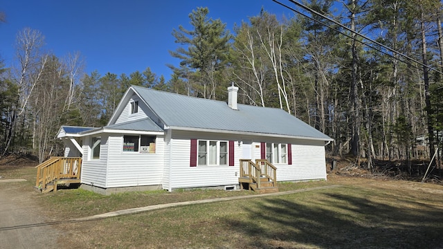 341 E Andover Rd, Andover, ME 04226 - view of front of home with metal roof, a front yard, and a chimney