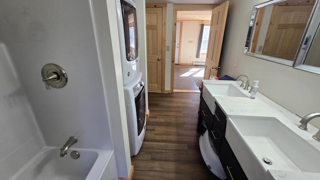 341 E Andover Rd, Andover, ME 04226 - bathroom featuring a sink, baseboard heating, stacked washer and dryer, and wood finished floors