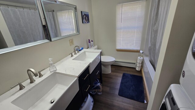 341 E Andover Rd, Andover, ME 04226 - bathroom featuring baseboard heating, vanity, toilet, wood finished floors, and shower / tub combo