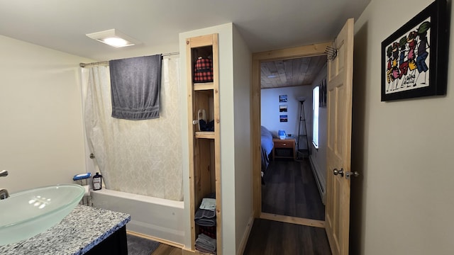 341 E Andover Rd, Andover, ME 04226 - full bath with wood finished floors, shower / tub combo, vanity, a baseboard radiator, and ensuite bath