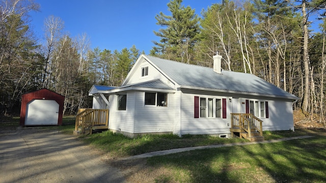 341 E Andover Rd, Andover, ME 04226 - view of front of home with an outdoor structure, a chimney, metal roof, and a front yard